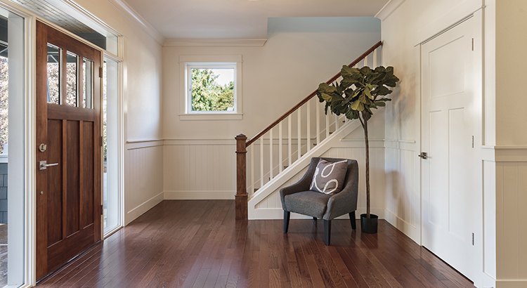 Armchair and potted tree in house entryway