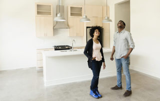 Couple standing in kitchen in new house
