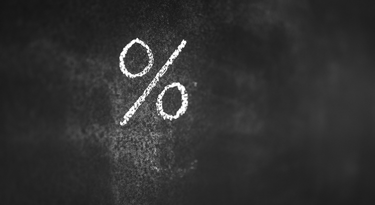 A percentage symbol written in white chalk on a blackboard.
