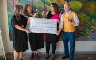 Metropolist co-founders and real estate brokers donating funds in service to Evergreen Trearment Services at REACH