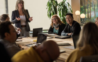 Domenica leading the Metropolist weekly meeting before real estate contracts class begins