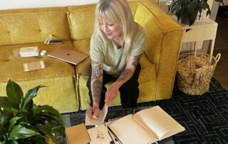 Real Estate broker writing handwritten notecards for her clients